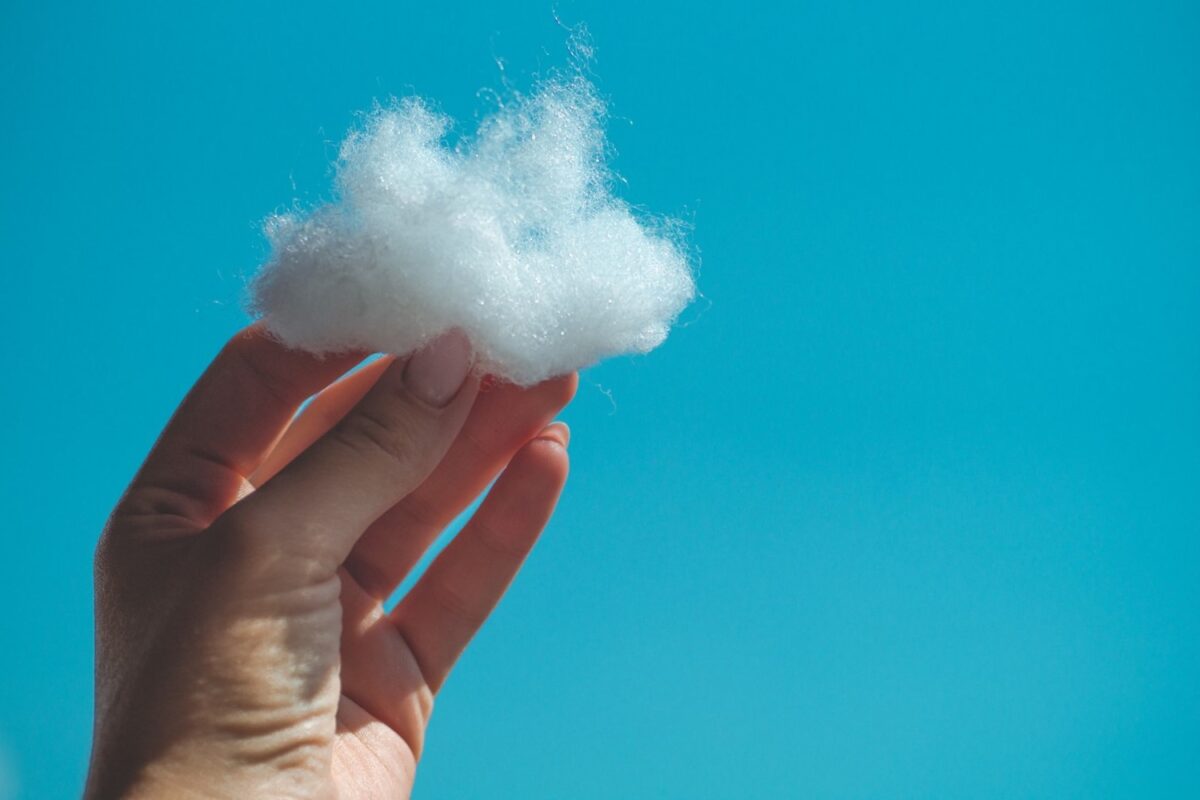 a woman's hand holding a tiny cloud